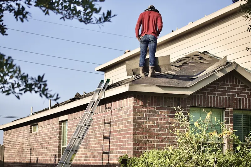 Professional roofer working on a residential roof in Williston